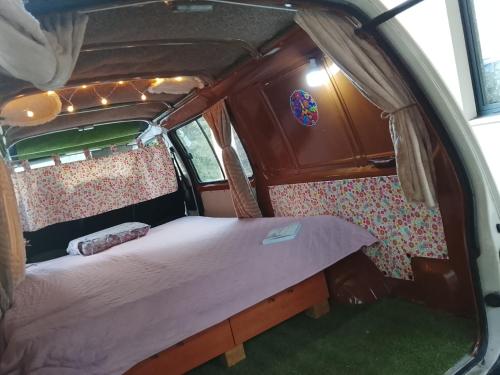 a bed in the back of a van with lights at Alojamento 4 in Monção