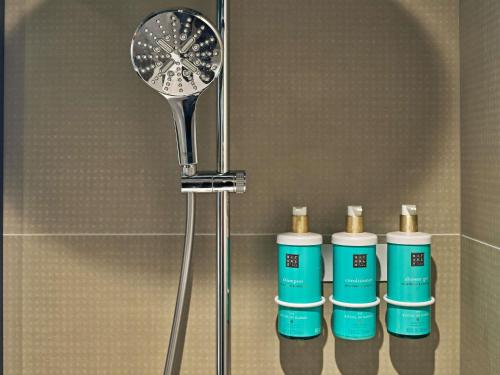 a group of four bottles ofodorizers in a bathroom at Novotel Rouen Centre Cathédrale in Rouen