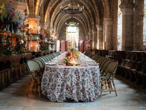 a long table in a large room with chairs at Abbaye Des Vaux De Cernay in Cernay-la-Ville