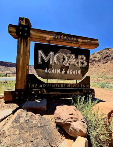 a sign for madab again and again in the desert at Corona Arch Cabin #04 in Moab