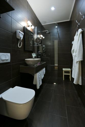 a bathroom with a toilet and a sink at Garni Hotel Zen free parking in Niš