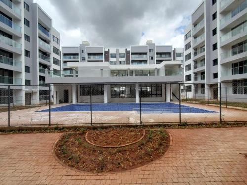 a large building with a courtyard in front of it at Mimah's cozy getaway near JKIA at Taurus Residences in Nairobi