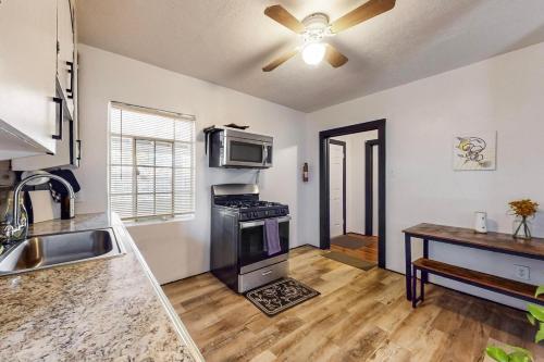 a kitchen with a stove and a microwave at Cozy 1br Casita in Southwest w Wifi! in Albuquerque