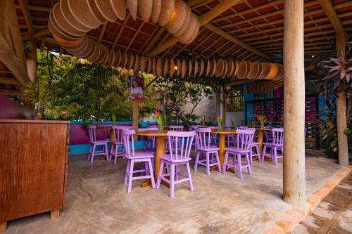 a group of tables and chairs in a restaurant at Vila Anauá in Japaratinga