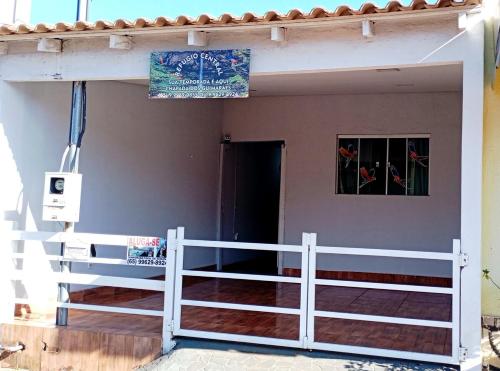 a porch of a house with a white fence at Refúgio Central in Chapada dos Guimarães