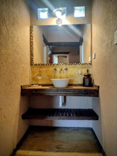 a bathroom with a sink and a mirror at Brisas de Chacras in San Javier