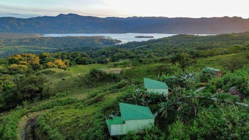 a house on a hill with a view of a lake at Villas Malu View Domos modernos con vista al Volcán Arenal in El Castillo de La Fortuna