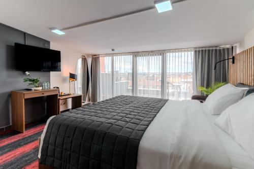 a hotel room with a bed and a large window at Vico hotel in Istanbul