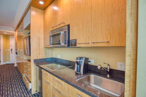 a kitchen with a sink and a microwave at Trump International Condo Hotel in Las Vegas