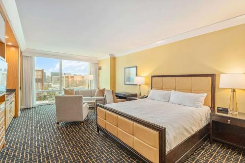 a hotel room with a bed and a large window at Trump Deluxe Studio Mountain View in Las Vegas