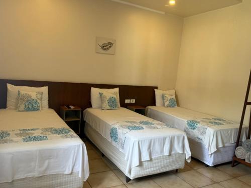 Ένα ή περισσότερα κρεβάτια σε δωμάτιο στο Caramelo hospedaria, localização privilegiada com conforto e privacidade