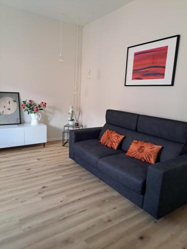 a living room with a blue couch in a room at Casa Mimì in Levane