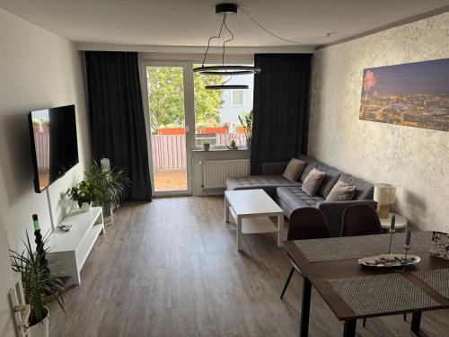 a living room with a couch and a table at Emilys 3 Room Apartment 70 qm in Hannover