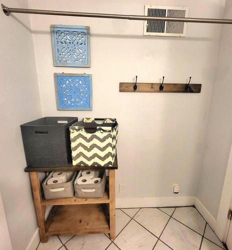 a room with a shelf with a box on a wall at The Crescent House in Hutchinson