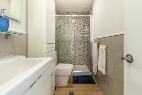 a white bathroom with a toilet and a shower at Guaires 217 in Mogán