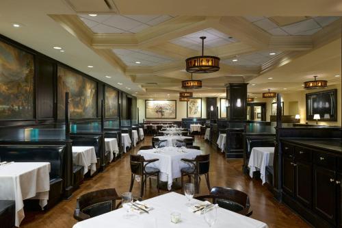 a dining room with white tables and chairs at The Westin Michigan Avenue Chicago in Chicago