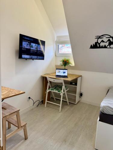 a room with a desk and a tv on the wall at 36-Maniana - DeerRest Apart in Jelenia Góra
