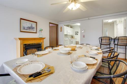 a dining room with a table with plates and chairs at Neenah Home with Deck Near Lake Winnebago in Neenah