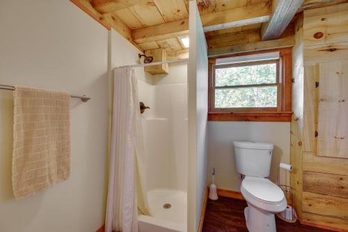 a bathroom with a toilet and a shower and a window at Unplug, Unwind and Explore Remote Vermont Cabin in Sharon