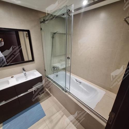 a bathroom with a glass shower and a sink at Almost Heaven Heated Pool Villa Taghazout Bay Amda in Taghazout