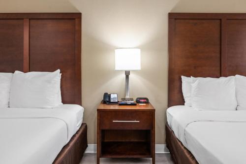 a hotel room with two beds and a table with a lamp at Comfort Inn Santa Cruz North in Santa Cruz