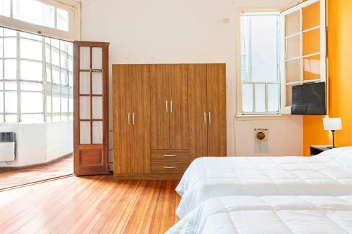 a bedroom with a bed and a television in it at Sentite en Casa in Buenos Aires