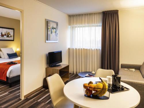 a hotel room with a bed and a table with fruit on it at Mercure Agen Centre in Agen