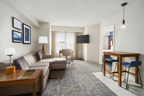a living room with a couch and a table at Residence Inn Orlando Lake Buena Vista in Orlando