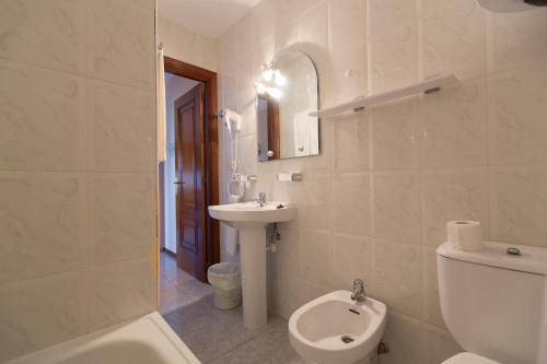 a white bathroom with a sink and a toilet at My Rooms City Hotel Monte Blanco in Neaño