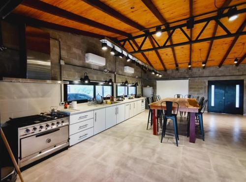 a large kitchen with a table and a dining room at ARROYO VEGA Casa 5ta in Esquina