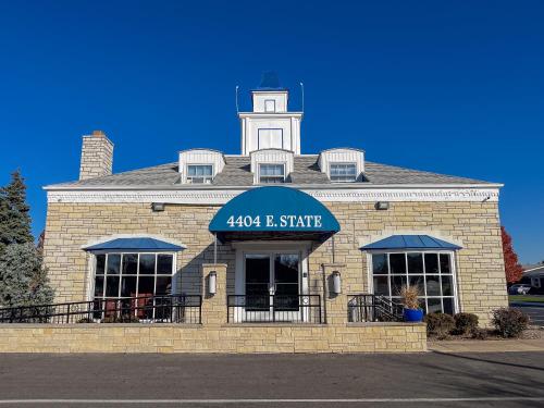 a brick building with a clock tower on top of it at Alpine Inn & Suites Rockford in Rockford
