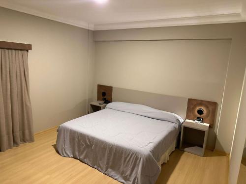 a bedroom with a bed and two night stands at ibis Styles Presidente Prudente Portal D'Oeste in Presidente Prudente