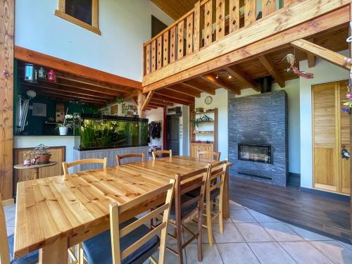 a large dining room with a wooden table and chairs at Louprayt in Saint-Julien-Chapteuil