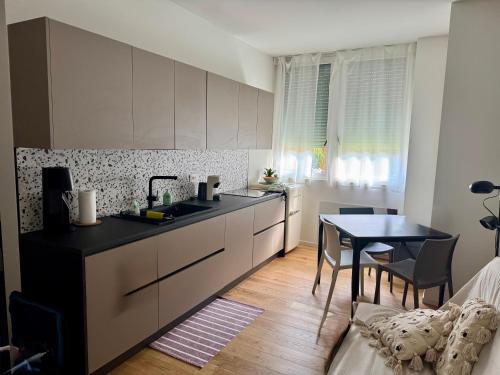 a kitchen with a table and a dining room at Affittacamere38A in Pordenone