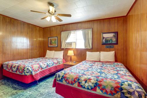 a bedroom with two beds and a ceiling fan at Walk to Greers Ferry Lake! Home with Dock Access in Greers Ferry
