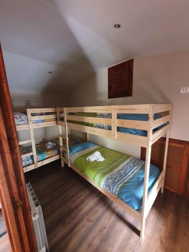 a room with three bunk beds in a room at Casa Rural Baratza in La Revilla de Herrán