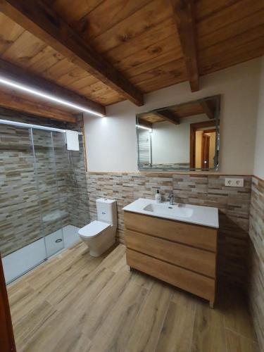 a bathroom with a sink and a toilet at Casa Rural Baratza in La Revilla de Herrán
