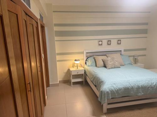 Una cama o camas en una habitación de Juan Dolio on the beach Beautiful beachfront apt