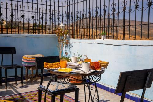 a table with a tray of food on a patio at Riad Misk Fez in Fès