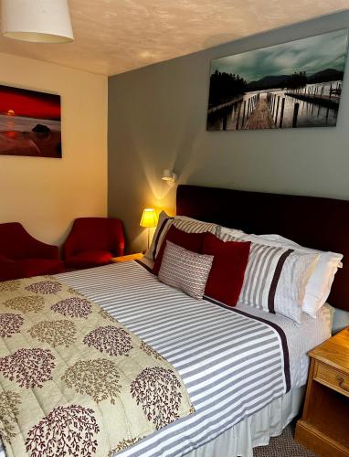 a bedroom with a bed with a white and black comforter at The Kings Head Inn in Gloucester