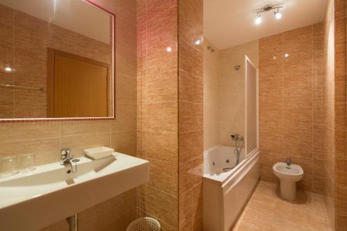 a bathroom with a sink and a toilet at My Rooms City Hotel Monte Blanco in Neaño