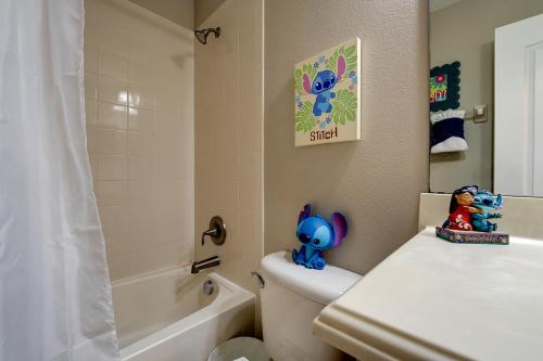 a bathroom with a toilet with figurines on it at NEW, Disney,10mi, Themed Rooms, PvtPool, Movie, Game Room in Kissimmee
