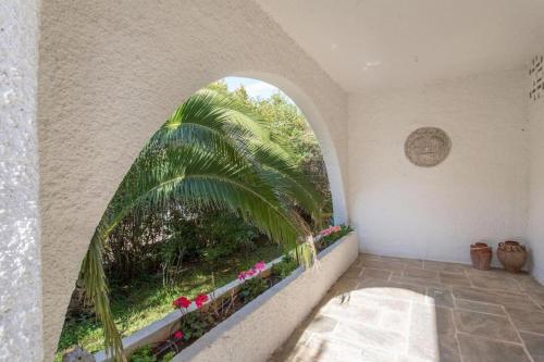 a room with a large window with a palm tree at Jacuzzi Artistic Villa in Nea Makri in Nea Makri