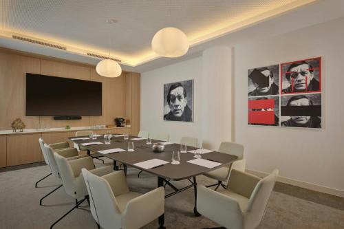 a conference room with a long table and chairs at AC Hotel by Marriott Nice in Nice