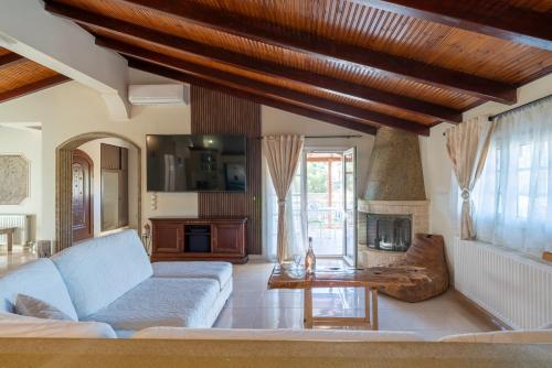 a living room with a couch and a fireplace at Liberis Loft Suite in Argostoli