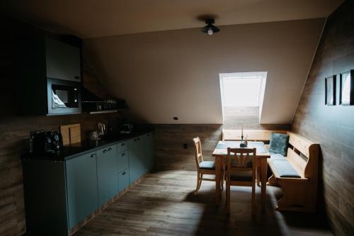 a kitchen and dining room with a table and chairs at eM Apartments in Vacov