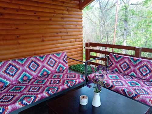 two beds on the porch of a cabin at Lozanski ambar in Boljevac
