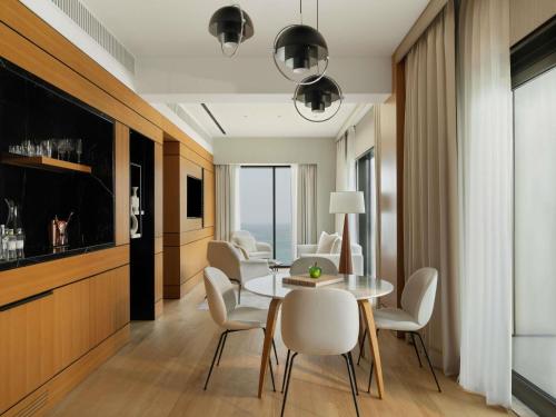 a dining room with a table and chairs at Delano Dubai at Bluewaters in Dubai