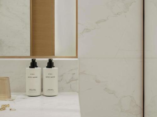 two bottles ofodorizers sitting on a counter in a bathroom at Delano Dubai at Bluewaters in Dubai
