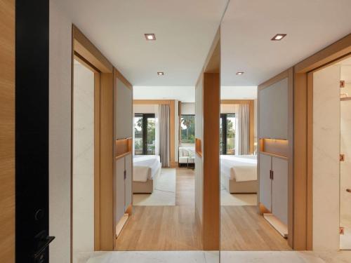 a hallway with a bedroom and a living room at Delano Dubai at Bluewaters in Dubai